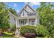 Charming two-story home featuring a cozy front porch and lush, mature landscaping at 220 W Winmore Ave, Chapel Hill, NC 27516