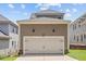 Detached two car garage with a white door in a well maintained home and yard at 220 W Winmore Ave, Chapel Hill, NC 27516