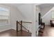 Hallway on second floor with hardwood floors, a staircase, and a doorway to another room at 220 W Winmore Ave, Chapel Hill, NC 27516