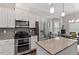 Bright kitchen features stainless steel appliances, white cabinets and granite countertops at 220 W Winmore Ave, Chapel Hill, NC 27516