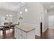 Open-concept kitchen features granite counters, an island, and stainless steel appliances at 220 W Winmore Ave, Chapel Hill, NC 27516
