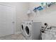Functional laundry room featuring a side-by-side washer and dryer and practical shelving for storage at 220 W Winmore Ave, Chapel Hill, NC 27516