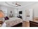 Cozy bedroom featuring a tray ceiling, and an ensuite bathroom entrance for added privacy at 220 W Winmore Ave, Chapel Hill, NC 27516