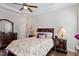 Inviting main bedroom with hardwood floors, tray ceiling, and a classic dresser and bedside tables at 220 W Winmore Ave, Chapel Hill, NC 27516