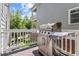 Outdoor stainless steel grill on a wooden deck with a white railing, great for entertaining guests at 220 W Winmore Ave, Chapel Hill, NC 27516