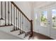 Elegant staircase features dark hardwood steps and decorative wrought iron railing at 220 W Winmore Ave, Chapel Hill, NC 27516