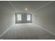 Spacious carpeted bedroom with two windows and trey ceilings for added dimension at 231 Paramount Dr, Smithfield, NC 27577