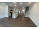 Open-concept living space features a kitchen island, stainless appliances, and an adjoining stairwell at 231 Paramount Dr, Smithfield, NC 27577