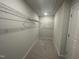 Walk-in closet with carpeted floor, overhead lighting, and adjustable wire shelving at 231 Paramount Dr, Smithfield, NC 27577