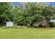 Large backyard featuring mature trees and a storage shed at 2312 Buckstone Ct, Fuquay Varina, NC 27526
