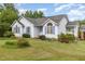 Inviting home featuring neat landscaping, complementary blue shutters, and architectural details at 2312 Buckstone Ct, Fuquay Varina, NC 27526