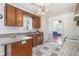 Traditional kitchen with granite counters, checkerboard floors, and wood cabinets at 2312 Buckstone Ct, Fuquay Varina, NC 27526