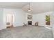 Open living room with vaulted ceilings, fireplace, and ample natural light, offering a cozy gathering space at 2312 Buckstone Ct, Fuquay Varina, NC 27526