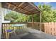 Covered patio with a weathered table and an outdoor chair at 2312 Buckstone Ct, Fuquay Varina, NC 27526
