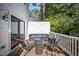 This cozy back deck features comfortable wicker seating with blue cushions at 2409 Basil Dr, Raleigh, NC 27612