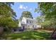 This home features a spacious backyard, a patio with seating, and mature trees at 2409 Basil Dr, Raleigh, NC 27612