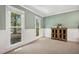 Cozy bedroom with wainscotting, neutral carpet and two large windows at 2409 Basil Dr, Raleigh, NC 27612