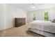 Bright bedroom features neutral decor, ceiling fan, and dresser with 7 drawers at 2409 Basil Dr, Raleigh, NC 27612