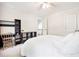 This bedroom features neutral walls, carpet flooring, desk, shelves, and access to the staircase at 2409 Basil Dr, Raleigh, NC 27612