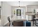 Bright eat-in kitchen features white cabinets and large bay window with built-in seating at 2409 Basil Dr, Raleigh, NC 27612