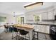 Bright eat-in kitchen features white cabinets, stainless steel appliances, a butcher block island and natural light at 2409 Basil Dr, Raleigh, NC 27612