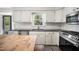 Bright kitchen features white cabinets, stainless steel appliances, and subway tile backsplash at 2409 Basil Dr, Raleigh, NC 27612