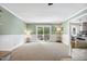 Open living room with sliding door to deck and view into the kitchen at 2409 Basil Dr, Raleigh, NC 27612