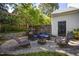 This home features a stone patio with lounge seating and an outdoor fireplace at 2409 Basil Dr, Raleigh, NC 27612