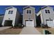 Exterior view of new townhomes featuring attached garages and manicured landscaping at 2459 Englemann Pl # 362, New Hill, NC 27562