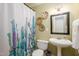A full bathroom is decorated with unique wall art and a modern shower curtain at 256 Marilyn Cir, Cary, NC 27513