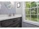 Bathroom featuring a dark wood vanity, modern sink, and a window providing natural light at 256 Marilyn Cir, Cary, NC 27513