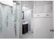 A bathroom with modern fixtures, shower with modern curtain, and neutral decor at 256 Marilyn Cir, Cary, NC 27513