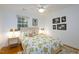 Bright bedroom features a floral bedspread, modern lighting, and charming decorative artwork at 256 Marilyn Cir, Cary, NC 27513