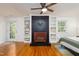 Primary bedroom with a painted fireplace and built-in shelves offering ample storage space at 256 Marilyn Cir, Cary, NC 27513