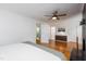 A clean primary bedroom showcasing a fireplace, hardwood floors and ensuite bathroom at 256 Marilyn Cir, Cary, NC 27513