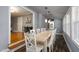Dining room featuring a long wooden table with white chairs and pendant lights at 256 Marilyn Cir, Cary, NC 27513