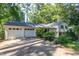 Charming home featuring an attached two-car garage and lush greenery at 256 Marilyn Cir, Cary, NC 27513