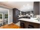 Bright kitchen with dark cabinetry, quartz countertops, and modern stainless appliances at 256 Marilyn Cir, Cary, NC 27513