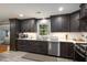 Modern kitchen features sleek dark wood cabinets and stainless steel appliances at 256 Marilyn Cir, Cary, NC 27513