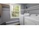 Functional laundry room with washer, dryer, and ample natural light at 256 Marilyn Cir, Cary, NC 27513