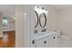 Bathroom featuring a double vanity with a white countertop and modern fixtures at 2609 Elmhurst Cir, Raleigh, NC 27610