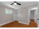 Bedroom showcasing hardwood floors, a window, and a closet with shelving at 2609 Elmhurst Cir, Raleigh, NC 27610