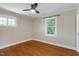 Bedroom features wood floors, ceiling fan, and windows overlooking the yard at 2609 Elmhurst Cir, Raleigh, NC 27610