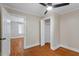 Bedroom featuring hardwood floors, a closet, and an open doorway at 2609 Elmhurst Cir, Raleigh, NC 27610