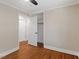 Cozy bedroom featuring hardwood floors, neutral walls, and a closet at 2609 Elmhurst Cir, Raleigh, NC 27610