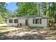 Charming single-story home featuring a brick facade, dark trim, and a well-manicured front yard at 2609 Elmhurst Cir, Raleigh, NC 27610