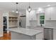 Well-appointed kitchen with stainless appliances, a center island, and sleek white cabinetry at 2609 Elmhurst Cir, Raleigh, NC 27610