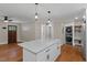 Open floor plan featuring a kitchen island with granite countertop and modern pendant lights at 2609 Elmhurst Cir, Raleigh, NC 27610
