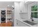 Bright kitchen with stainless appliances, granite counters, laundry, and modern fixtures at 2609 Elmhurst Cir, Raleigh, NC 27610