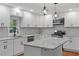 Bright kitchen features white cabinets, stainless steel appliances, granite countertops, and eye-catching backsplash at 2609 Elmhurst Cir, Raleigh, NC 27610